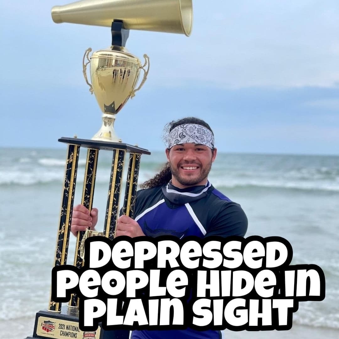 Kollin Mark Cockrell: Male cheerleader holding trophy by the sea
