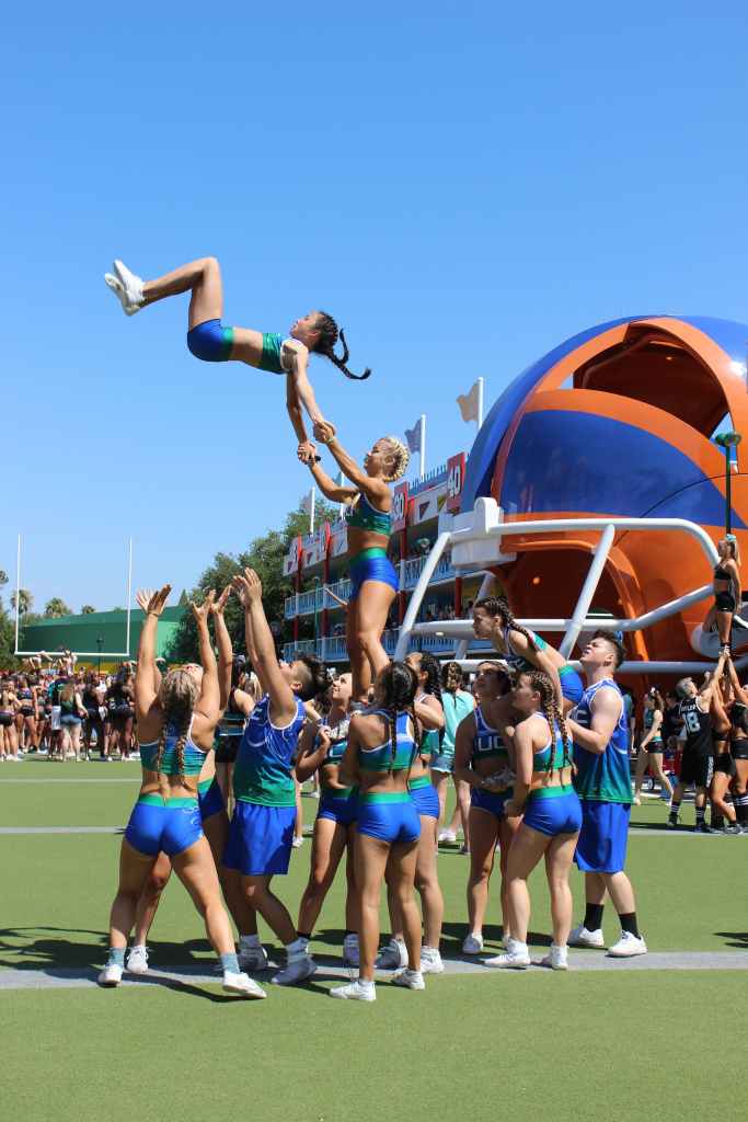 Group of male and female cheerleader stunting